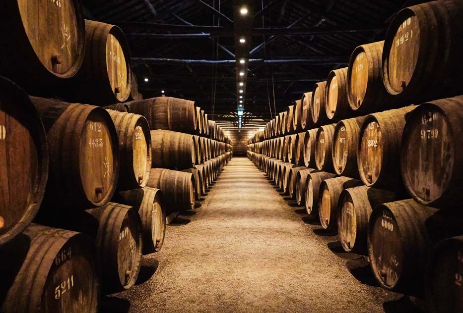 Tall racks of maturing barrels in a spirits warehouse