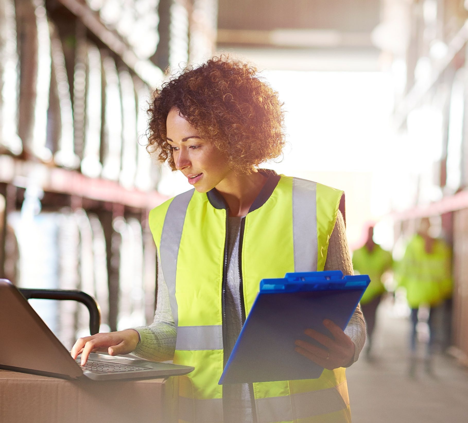 Worker checking stock with a clipboard in a warehouse