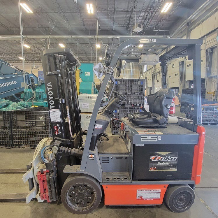 Forklift moving pallets in a distribution centre aisle